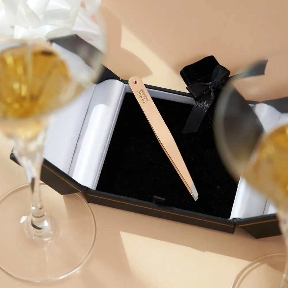 Rose gold tweezers in an open gift case