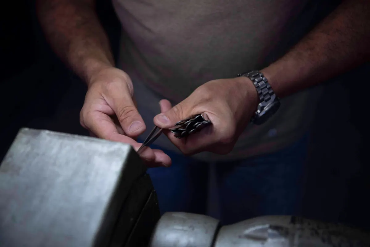 Hands finishing a pair of tweezers