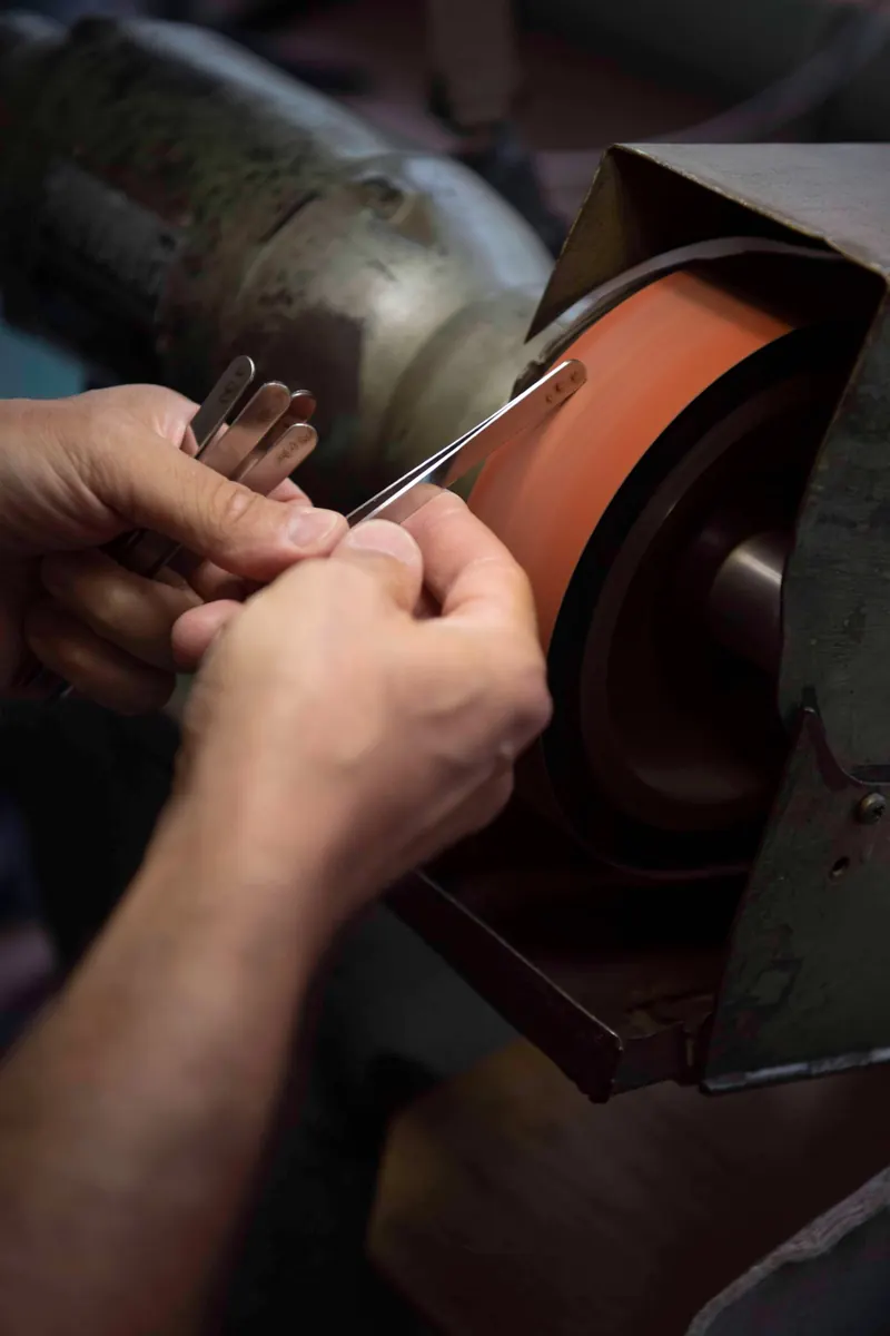 Rubis tweezers being finished on a grinding wheel